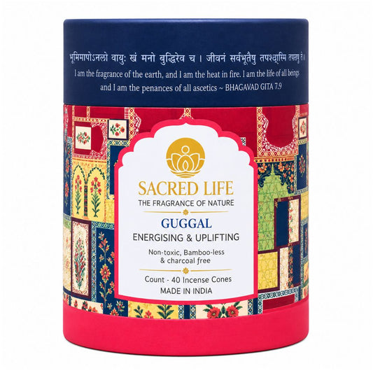 A cylindrical tin of Sacred Life Gugg incense cones, featuring a navy blue top band with Sanskrit and English text, a central white label with gold and blue text, and a colorful patchwork border illustration.